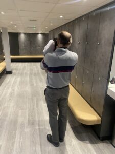 STax surveyor photographing fixtures and fittings in a commercial changing room during a capital allowance inspection to identify qualifying assets for tax relief.